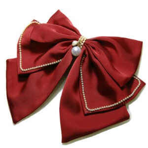 Red bow hair clip for wedding hairstyle